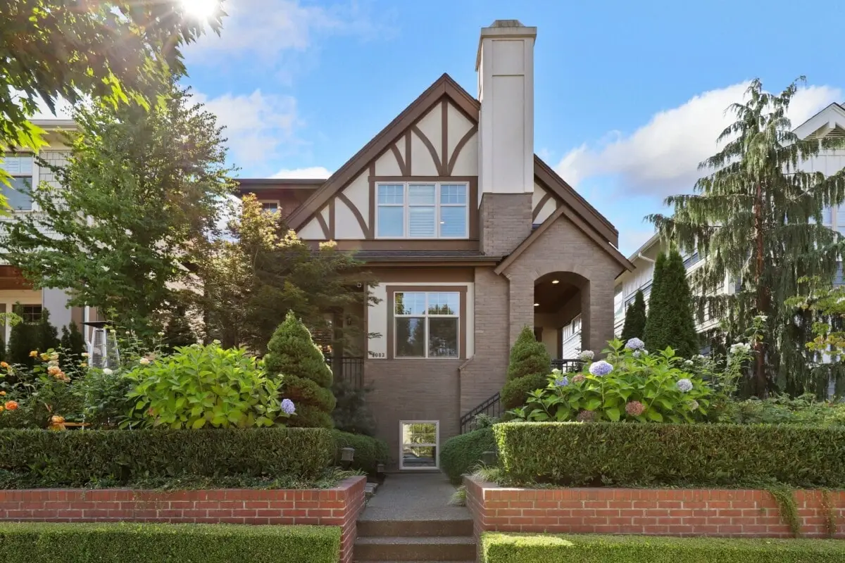 Well-maintained suburban home with landscaped yard and front entrance