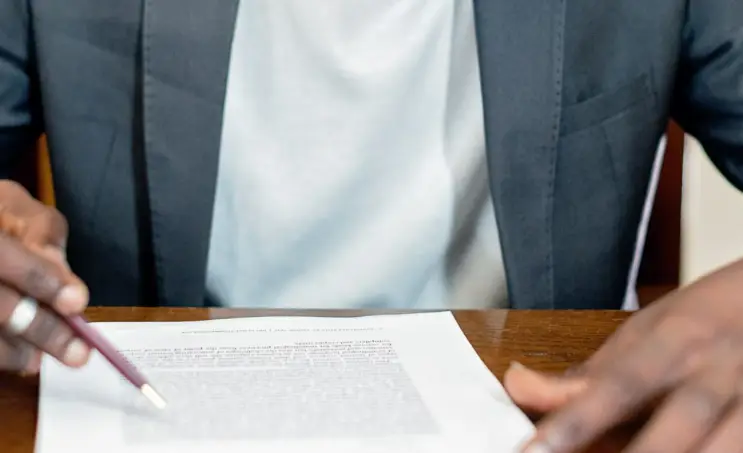 Person reviewing a document during a meeting