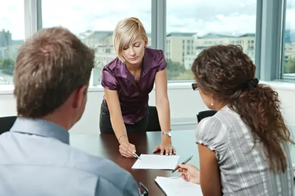 Professional discussing options with a couple during a meeting
