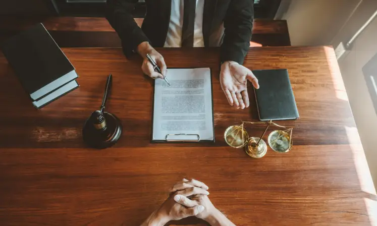 People reviewing a document together at a table during a meeting
