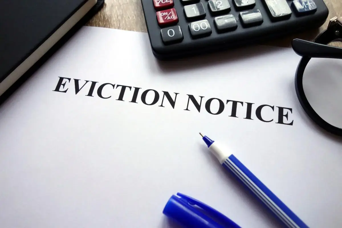 Eviction notice with a calculator and pen