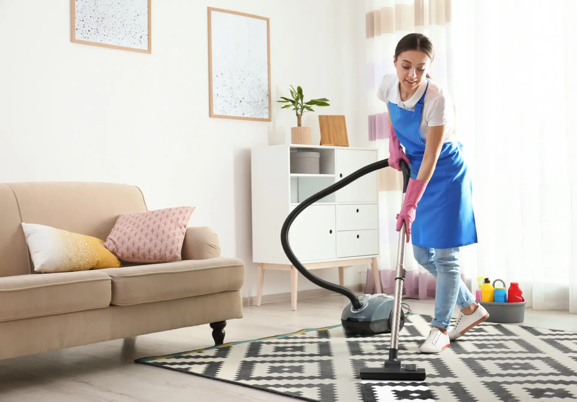 Woman vacuuming floors in a home