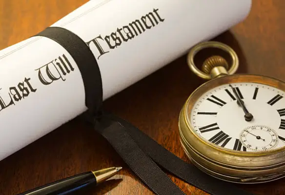 Last will and testament document with pocket watch representing estate planning and inheritance