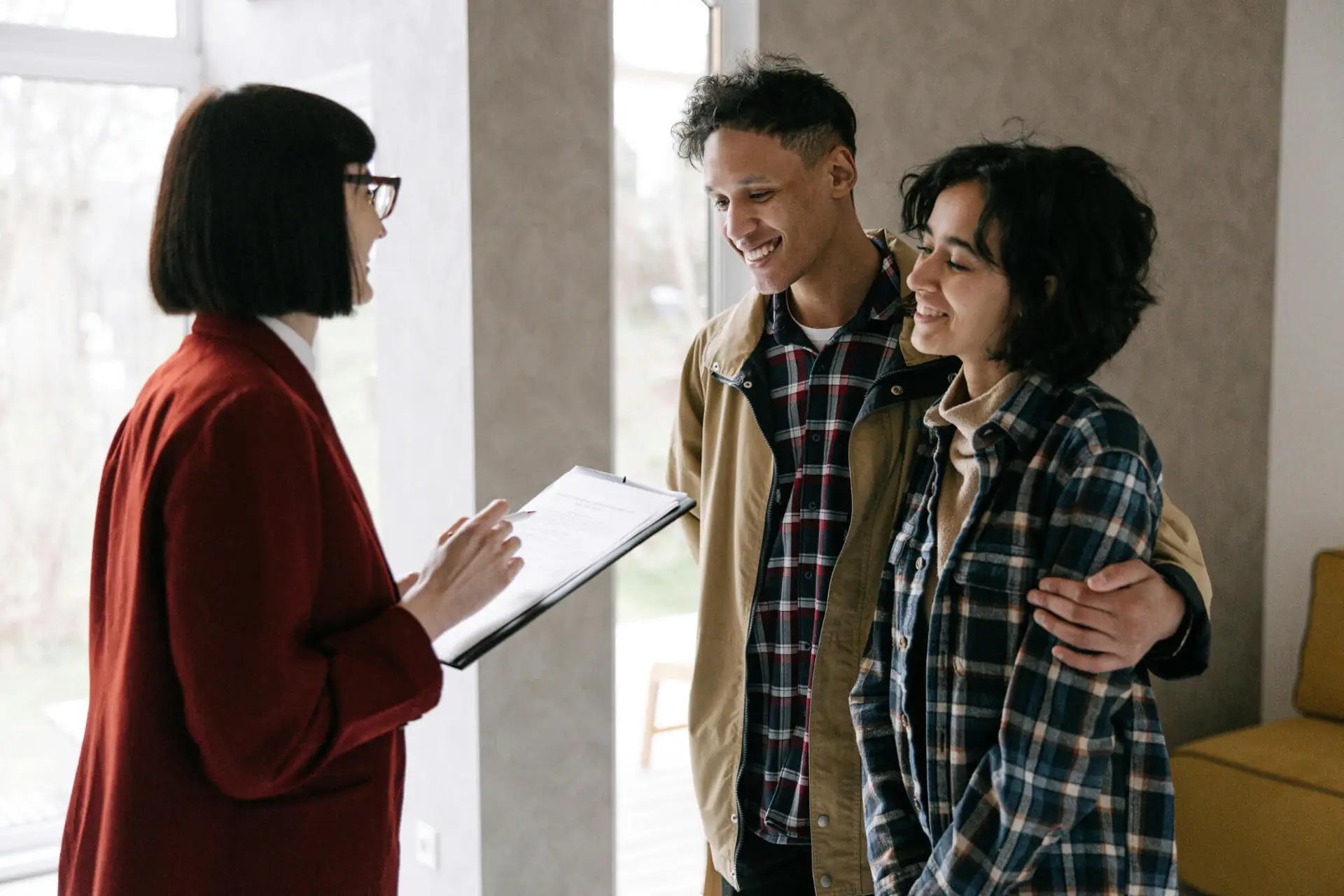 Out-of-state home buyers meeting with a real estate agent to view a property